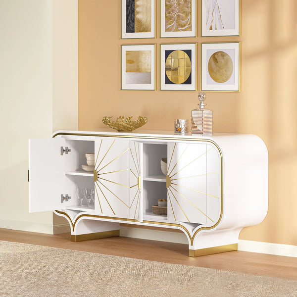 White and gold 4-door buffet with decorative items against a beige wall with framed art.